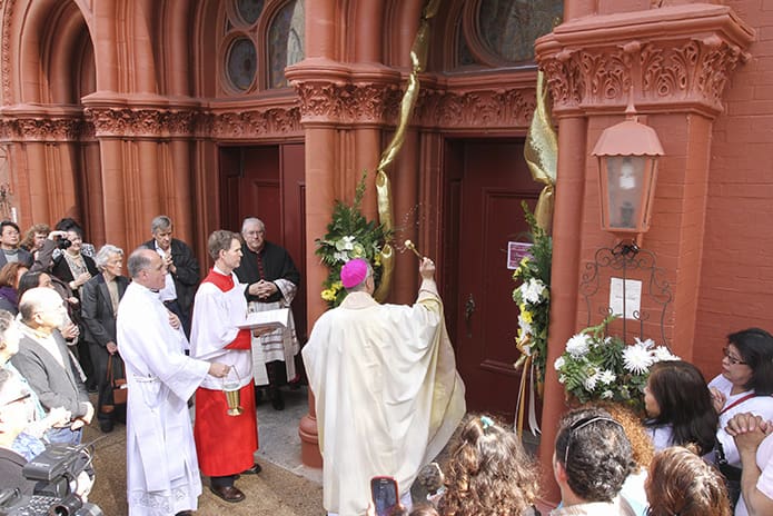Bishop Luis Zarama sprinkles holy water on the Holy Door of Mercy at Sacred Heart of Jesus Basilica, Atlanta, on the Feast of the Presentation of the Lord, Feb. 2. Photo by Michael Alexander