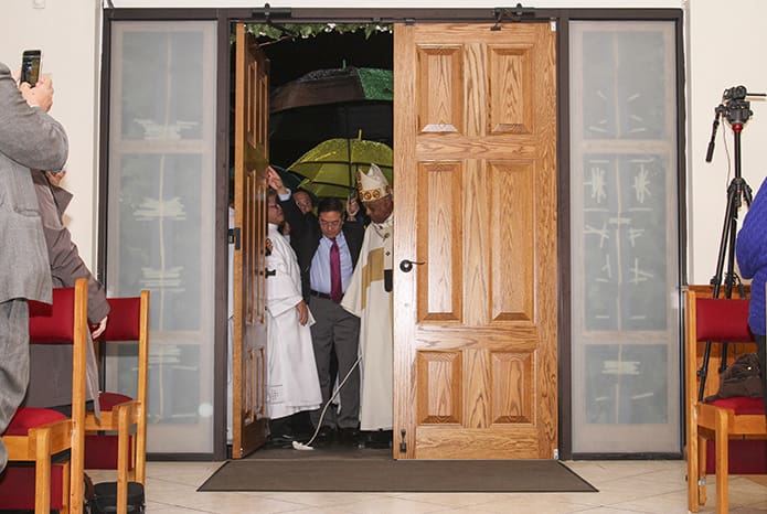 On Feb. 22, the Feast of the Chair of Saint Peter, the tassel on the Holy Door of Mercy at the Holy Vietnamese Martyrs Church in Norcross is removed and the door is opened to a waiting congregation. Photo By Michael Alexander