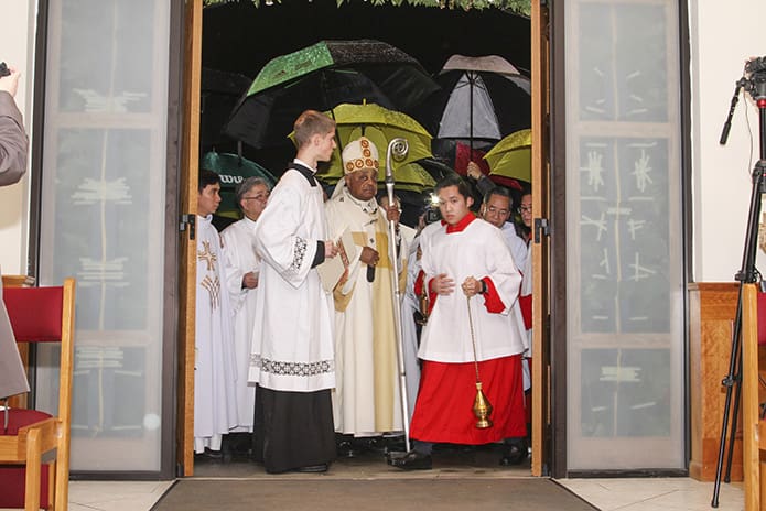 Altar servers prepare to lead the clergy, including Archbishop Wilton D. Gregory, center, through the Holy Door of Mercy and into the church sanctuary. Photo By Michael Alexander