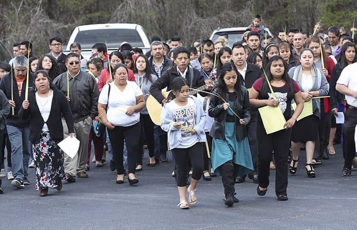 Parishioners at St. Paul the Apostle Church, Cleveland, process to the church from the lower parking on Palm Sunday. Photo By Michael Alexander