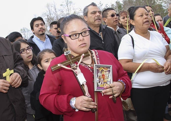 Eighteen-year-old Yuliza Lara prepares to enter St. Paul the Apostle Church, Cleveland, with fellow parishioners during a March 20 Palm Sunday procession. Photo By Michael Alexander
