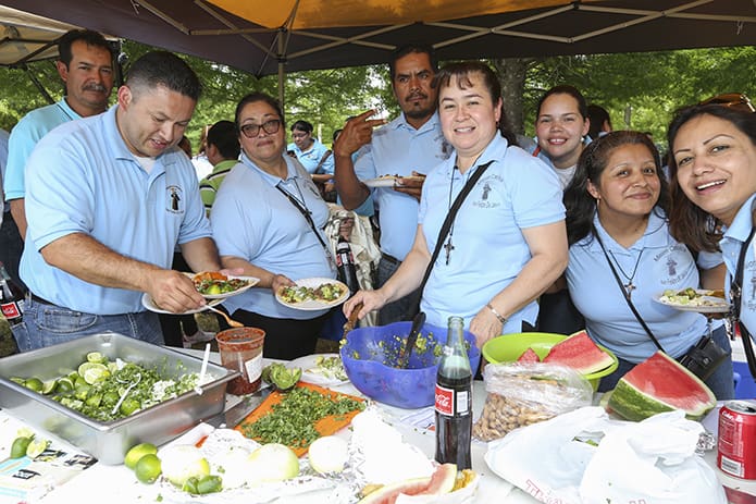 Parishioners from San Felipe de Jesus Mission, Forest Park, gather as a community during lunch where they enjoyed soft tacos and other prepared food. Photo By Michael Alexander