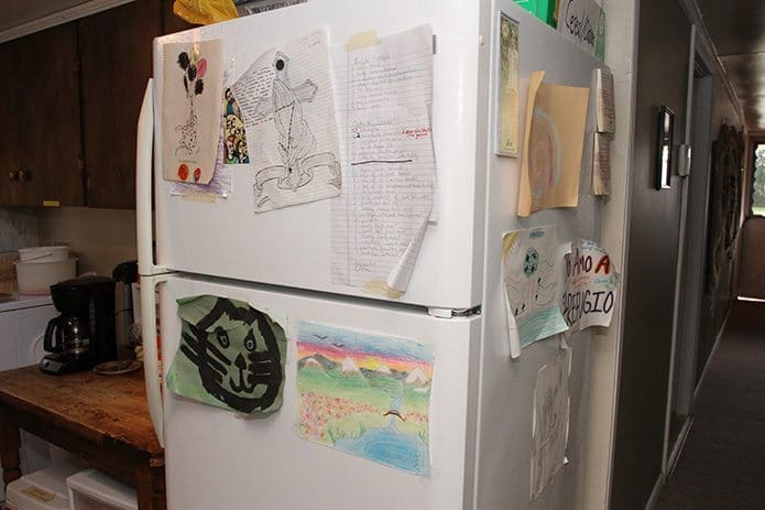 Artwork and notes of gratitude, done by guests of the hospitality house and detainees, are displayed on the refrigerator at El Refugio. Photo By Michael Alexander