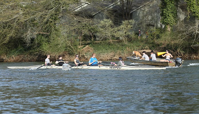 (R-l) Novice men’s coach Elizabeth Barnett yells out instructions to some rowers on the port side of her coaching launch. In the boat with her are (r-l) Walton High School sophomore Sajan Patel, Dickerson Middle School eighth-grader Aidan Risey and the unofficial team mascot, a hound mix name Stevie. In the other boat are (r-l) coxswain Anna Beth Cadenhead, John Chapman, James Owen, Eric Emmenegger and Grant Irby. Photo By Michael Alexander