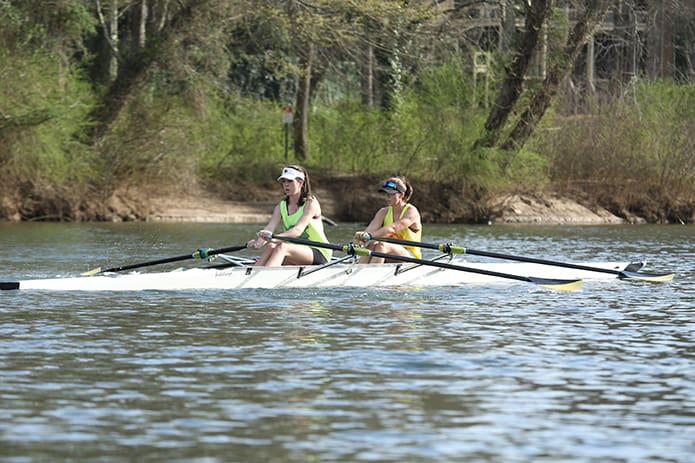 (L-r) Gillian Burns and Riley Kerber, seniors at Alpharetta High School and Walton High School, respectively, row in a double shell on the Chattahoochee River in Roswell. Burns and Kerber will be rowing on the University of Louisville women’s team in college. Photo By Michael Alexander