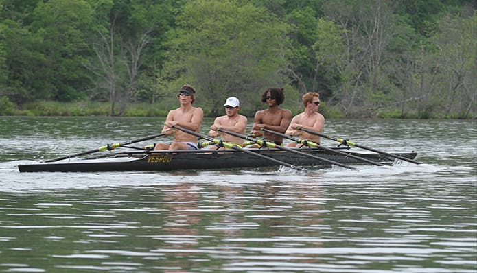 Matt Moore, far right, a senior at Mill Creek High School, Hoschton, looks behind for oncoming boat traffic along the Chattahoochee River. He shares a quad shell (four rowers and no coxswain) with (l-r) Max Shaffer, a junior at Chattahoochee High School, Alpharetta, Jason Peacock, a junior at Walton High School, Marietta, and Jerome Yankey, a junior at Centennial High School, Roswell. Photo By Michael Alexander