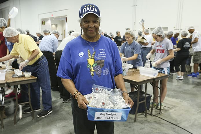 Jeanne Marie Mosley, 78, of Most Blessed Sacrament Church, Atlanta, served as a runner between tables at Starve Wars. Mosley picked up sealed meal bags from tables and took them to the boxing stations. At the end of Starve Wars’ first session 38,000 meal bags were packed. Photo By Michael Alexander
