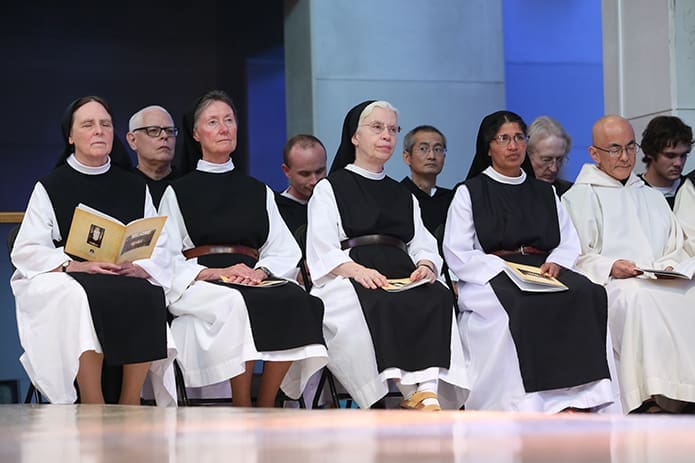 On the altar listening to the Liturgy of the Word during the abbatial blessing are Order of Cistercians of the Strict Observance nuns including (l-r) Mother Maureen McCabe of Mount St. Mary’s Abbey, Wrentham, Mass., Mother Vickie Murray of Santa Rita Abbey, Sonoita, Ariz., Mother Marion Rissetto and Sister Sophy Mathew of Our Lady of the Angels Monastery, Crozet, Va., and Brother Nathanael Felarca of the Monastery of the Holy Spirit, Conyers. Photo By Michael Alexander