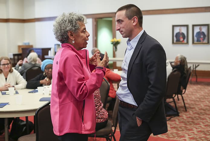 During a break in the program, Shreveport, La., native and St. Anthony of Padua Church parishioner Merrine McDonald, left, speaks with Michael Pasquier, associate professor of Religious Studies and History at Louisiana State University, Baton Rouge, and one of the morning speakers who gave a presentation on the history of racism in the Roman Catholic Church. Photo By Michael Alexander