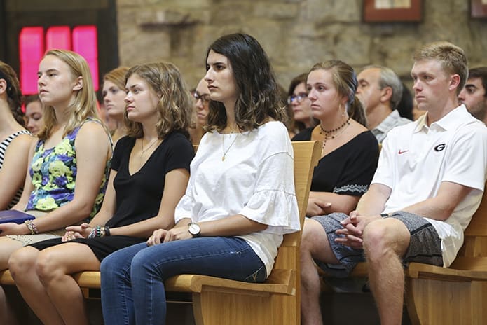 University of Georgia freshmen students (r-l, front pew) Mariana Hernandez of Carrollton, Isabella Dobbins of Savannah, and Olivia Macik of Atlanta were among the 500 young students who provided a captive audience for Archbishop Wilton D. Gregory to address the hate and racism of white supremacists that permeated the University of Virginia in Charlottesville, Va., the week before their arrival to the Athens campus. Photo By Michael Alexander