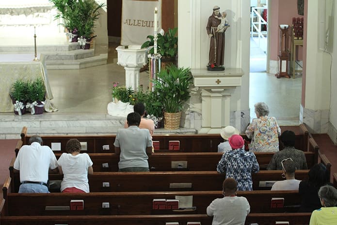 A group of parishioners pray at St. Anthony of Padua Church for Atlanta Prays. They united in prayer for an end to some of the ills facing the Metro Atlanta community like human trafficking. St. Anthony was a May 6, inside the perimeter host site for the west side of the city. In addition to prayer and meditation under the theme of Forgiveness, Repentance and Healing, the pastor, Father Victor Galier, heard confessions and concluded the five-hour period of prayer with a Mass. Photo By Michael Alexander