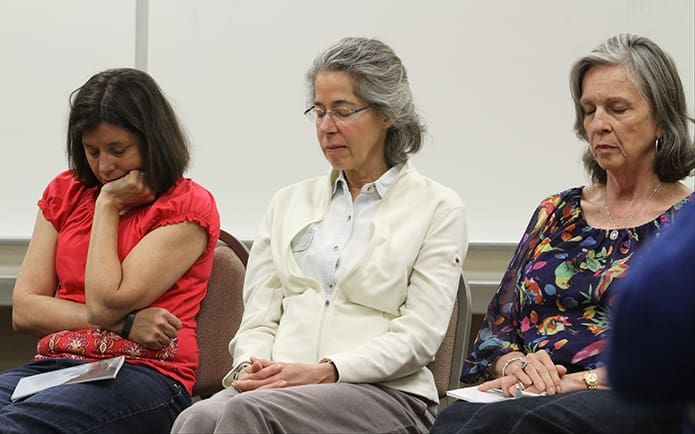 (L-r) Karen Pinsonneault, Karen Hughes and Deborah Holcomb pray with others for the victims of domestic sex trafficking. The prayer was led by Mary Francis Bowley, founder and chief strategy officer of Wellspring Living, a non-profit that helps to restore the lives of domestic sex trafficking victims. Photo By Michael Alexander