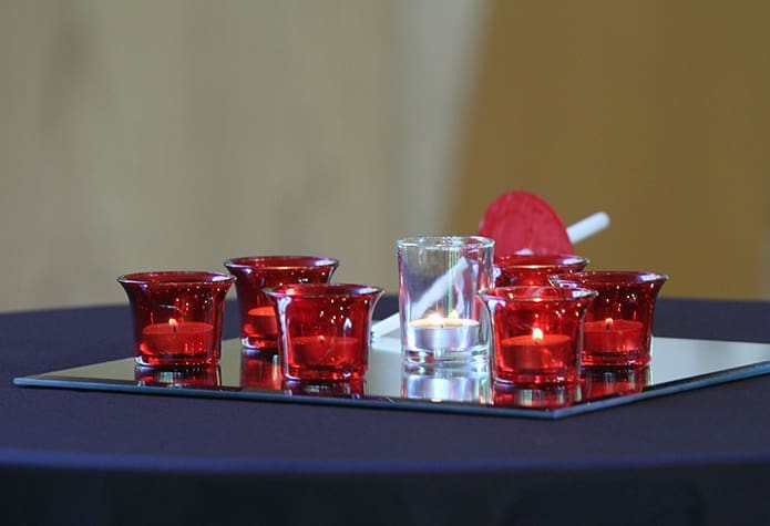 In the sanctuary at St. Philip Benizi Church six, red candles burn for the victims of human trafficking, modern day slavery, exploited laborers, child soldiers, those afflicted by disease or shame and for the women and girls abused throughout society. The white candle in the center represents our prayers and assistance for the victims mentioned above. The Jonesboro parish was an outside the perimeter host site for the south side of the city on May 6, the third day of 125 Hours of Prayer. Photo By Michael Alexander