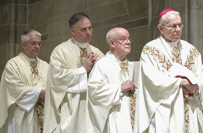 Diamond jubilarian Msgr. R. Donald Kiernan, second from right, pastor of All Saints Church, Dunwoody, stood with (l-r) silver jubilarians Father Albert Jowdy, pastor of St. Lawrence Church, Lawrenceville, and Father James Schillinger, pastor of Immaculate Heart of Mary Church, Atlanta, and Archbishop-emeritus John F. Donoghue during the reading of the Gospel at the June 4, 2009 jubilarian Mass. Photo By Michael Alexander