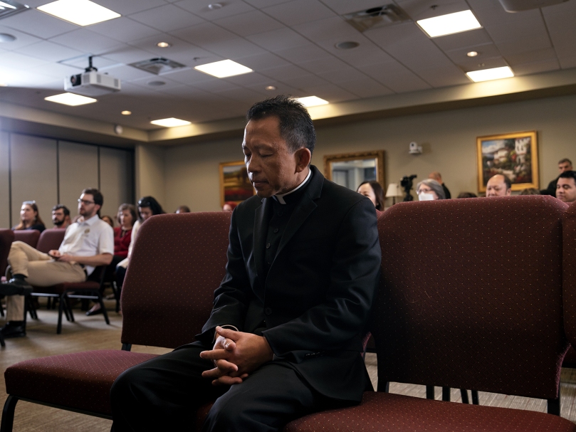 Bishop-designate John Nhan Tran bows his head during the opening prayer of a press conference announcing his appointment at the Chancery of the archdiocese Oct. 25. Photo by Johnathon Kelso