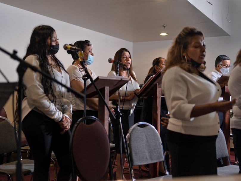 The choir of San Felipe de Jesús Mission rehearses before the Mass held in honor of Bishop-designate Jacques E. Fabre-Jeune, CS. The Scalabrininan priest led the mission community for 13 years. Photo by Johnathon Kelso