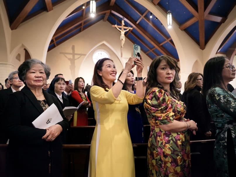 The faithful view the opening procession during The Episcopal Ordination of His Excellency The Most Reverend John Nhàn Tran at Saint Peter Chanel Church in Roswell, Ga., on January 23, 2023. Photo by Johnathon Kelso