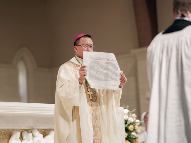 Bishop John Nhan Tran shows the apostolic letter announcing his appointment by the pope to serve as an auxiliary bishop for Atlanta. Photo by Johnathon Kelso
