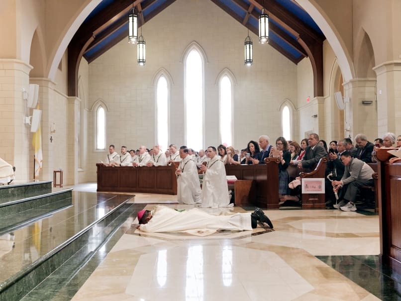 Bishop John Nhan Tran lies prostrate during the Litany of Supplication at St. Peter Chanel Church in Roswell. Photo by Johnathon Kelso