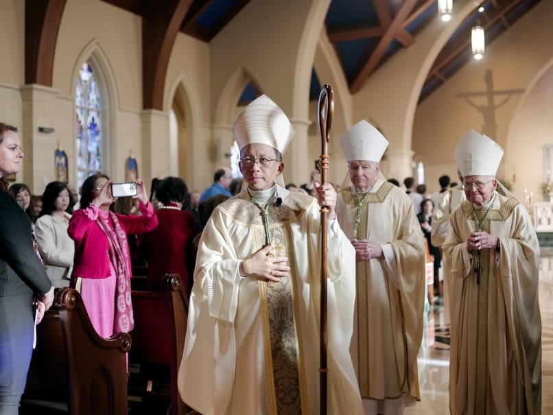 Bishop John Nhàn Tran greets the faithful after his ordination at St. Peter Chanel Church in Roswell. Following are Gregory M. Aymond, Archbishop of New Orleans, left, and Archbishop-emeritus Alfred C. Hughes of New Orleans, right. Photo by Johnathon Kelso