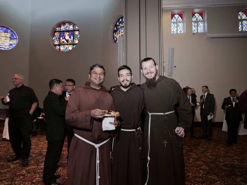 Capuchin Franciscans Brother Praveen Turaka, left, Brother Franco Chavez, center, and Brother CJ Webb, right, pose for a photograph during a reception held following the Episcopal Ordination of John Nhàn Tran. Photo by Johnathon Kelso