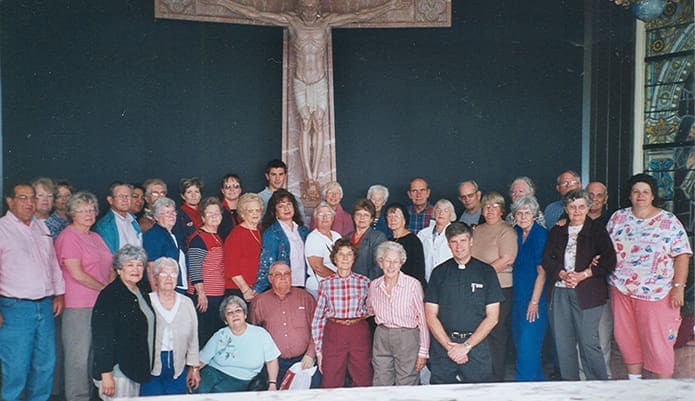 Father Bernard E. (Ned) Shlesinger III, kneeling, front row, right, poses with parishioners from Our Lady of Guadalupe Church, Newton Grove, N.C., during a 2004 parish pilgrimage to the Shrine of the Most Blessed Sacrament, Hanceville, Ala. Photo Courtesy of Our Lady of Guadalupe Church
