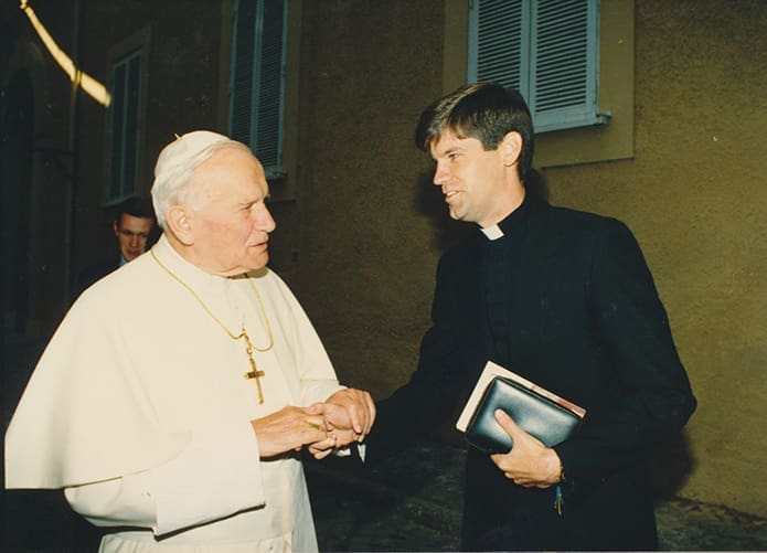 In 1993 seminarian Bernard E. (Ned) Shlesinger III, right, is greeted by Pope John Paul II at Castel Gandolfo, some 15.5 miles southeast of Rome, Italy, during his time of study at the Pontifical North American College in Rome. Photo Courtesy of Shlesinger Family
