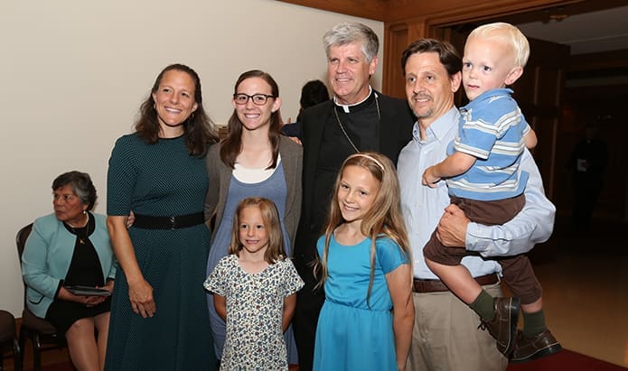 During the reception that followed the vespers service, Bishop-designate Bernard E. (Ned) Shlesinger III, right center, stands with (clockwise, starting second from right) Tim Stickney, his son Karl, 2, his daughters Katherine, 10, and Karolyne, 6, his wife Sheryl and his daughter Kristine, 18. The Stickney family belongs to St. Joseph Church, Raleigh, N.C. Photo By Michael Alexander