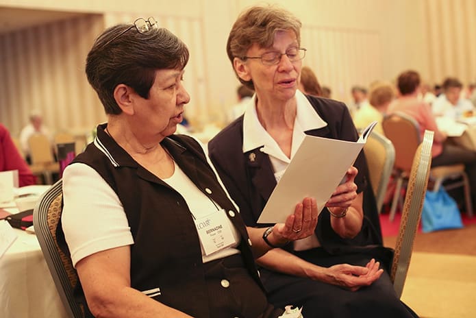 Sisters of the Order of St. Benedict Bernadine Reyes of Boerne, Texas, and Daughters of Charity Sister Mary Walz of St. Louis, Mo., recite the closing prayer to conclude the morning session on Racism and U.S. Religious Life August 12. Photo By Michael Alexander
