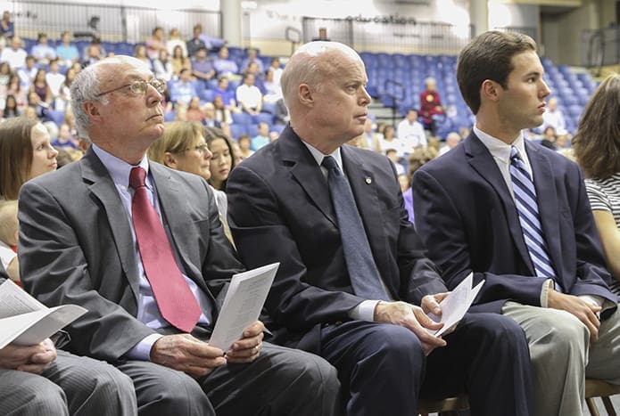 (L-r) Mike Trapani, Marist School dean of students, Clarence Smith, Marist alumnus, and Gus Phelts, a Marist senior and co-president of the student body, listen as Bishop-designate Joel M. Konzen, SM, the school’s former principal, delivers his homily. Photo By Michael Alexander