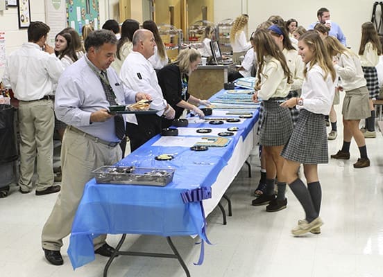 Blessed Trinity High School faculty and students were treated to chocolate chip cookie cake and yellow cake, with blue and white cream cheese icing, during all the lunch periods to mark the schoolâs recognition as a 2014 National Blue Ribbon School of Excellence. Photo By Michael Alexander