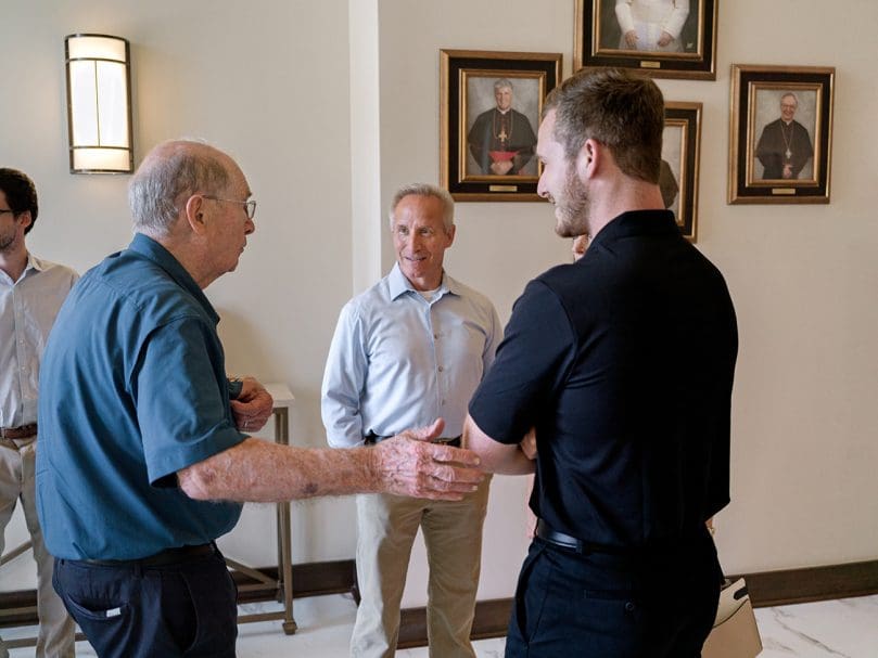 Seminarian Mark Piendel, right, speaks with family before the the candidacy Mass held at Christ the Redeemer Church on July 27. Photo by Johnathon Kelso