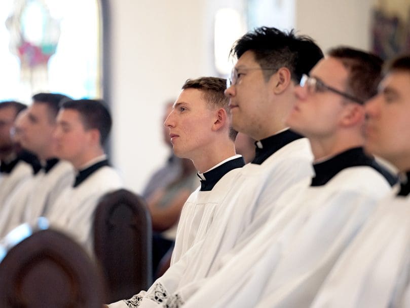 Seminarians listen to the Liturgy of the Word during the candidacy Mass. Photo by Johnathon Kelso