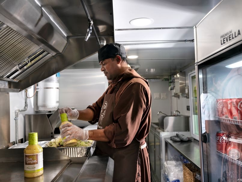 Capuchin Franciscan Brother Praveen Turaka prepares food inside the truck at the Shrine of the Immaculate Conception in Atlanta. The  friars open the food truck twice a week. Photo by Johnathon Kelso