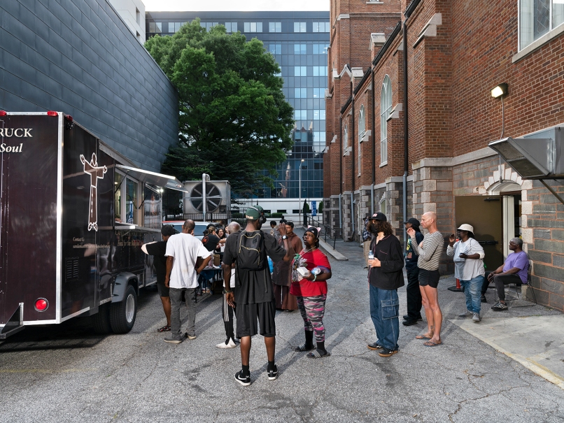 People arrive for a meal at the Capuchin food truck at the Shrine of the Immaculate Conception in Atlanta. The ministry helps feed those without shelter and others trying to stretch their meal dollars. Photo by Johnathon Kelso
