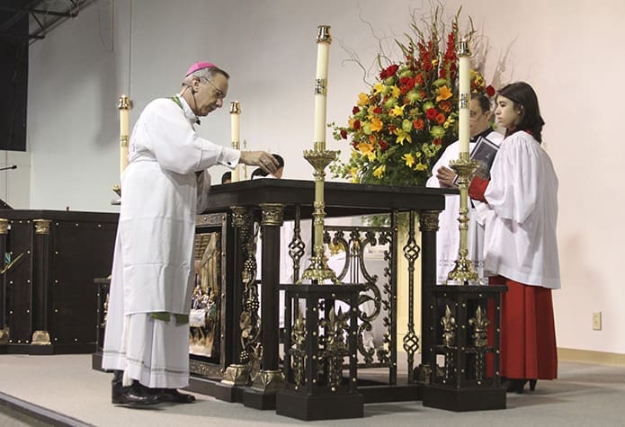 Bishop Luis Zarama anoints the altar with chrism during the rite of dedication. Photo By Michael Alexander