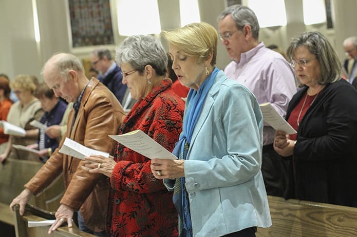 (Counterclockwise, from left) Larry Johnson, Cathy Davies and Loudell Printz of Christ the King Lutheran Church, Peachtree Corners, and Janie and Mark Langheim of St. Monica Church, Duluth, join the rest of the congregation in praying the Nicene Creed. Photo By Michael Alexander
