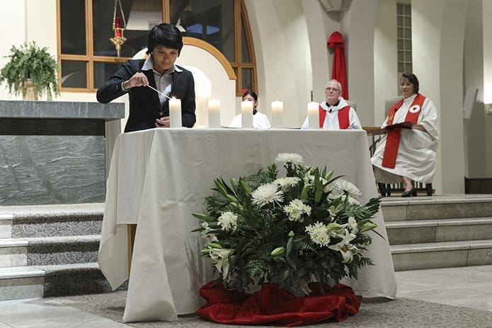 Brenda Moncada of St. Andrew Church, Roswell, was the fifth of five teens, three Catholic and two Lutheran, who lit a candle representing each commitment between Catholics and Lutherans. Photo By Michael Alexander