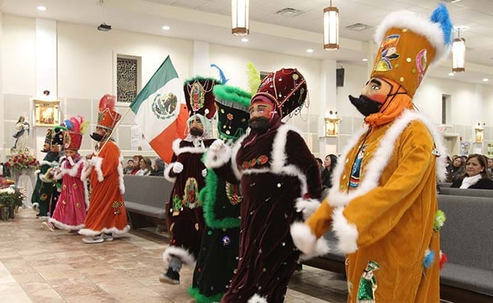 Members of Chinelos De Miacatlán Morelos of Norcross perform a liturgical dance after the offertory procession of the Dec. 12 Our Lady of Guadalupe Mass at Divino Niño Jesús Mission in Duluth. Photo By Michael Alexander