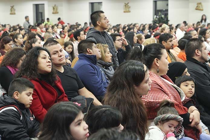 Between the main sanctuary and the overflow space in the parish hall at San Felipe de Jesús Mission, Forest Park, some 2,000 people were on hand for the Dec. 11 Mass on the evening preceding the feast of Our Lady of Guadalupe. That number doesn't account for the additional 2,000 who were either standing outside or came for the post Mass celebration. Photo By Michael Alexander