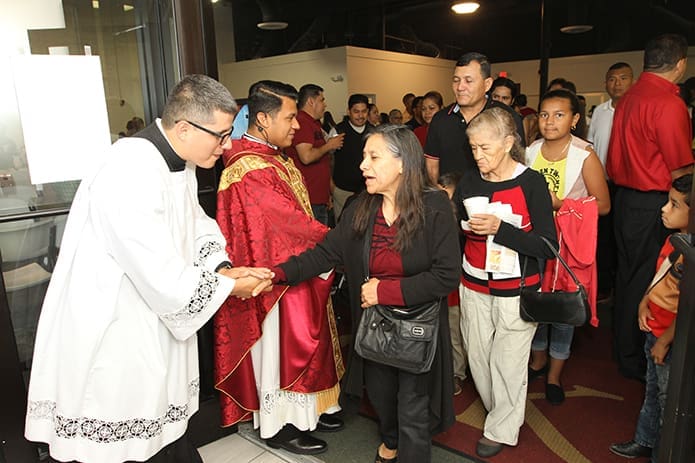 Seminarian Juan Villota, foreground left, and Cathedral of Christ the King parochial vicar Father Rey Pineda greet exiting members of the congregation after Mass on Pentecost Sunday. Photo By Michael Alexander