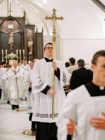 DAWSONVILLE, GA - NOVEMBER 1, 2021: The processional cross is carried out of the sanctuary followng the dedication of the church and altar at Christ the Redeemer Church. Photographer: Christine Clements