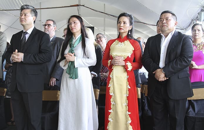 (L-r) Thanh Danh Nguyen, his wife Kim-Anh Dinh, Minh-Vien Nguyen, and her husband Cong Chinh stand for the reading of the Gospel from Matthew’s sixteenth chapter. Thanh Danh and Cong Chinh are members of the church building committee. Photo By Michael Alexander