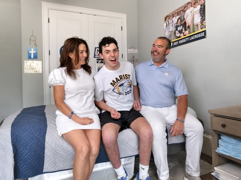 Melinda and Brian Corbett and their youngest son Devon are photographed at their Buckhead home. “He’s already a miracle," said Melinda about her son and his progress since a 2020 brain injury. Photo by Johnathon Kelso