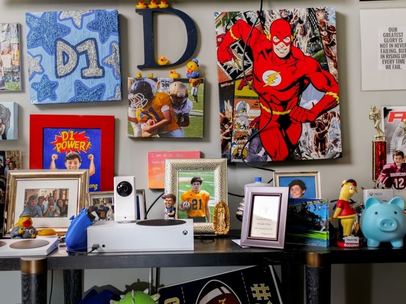 Photographs and art from Devon Corbett's childhood are pictured inside his bedroom. Photo by Johnathon Kelso.