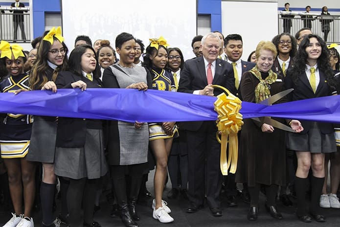 Governor Nathan Deal, holding the scissors, prepares to participate in the Jan. 30 ribbon cutting ceremony at Cristo Rey Atlanta Jesuit High School. Looking on among the students are Diane Bush, second from right, school principal, and Atlanta Mayor Keisha Lance Bottoms, fourth from left. Photo By Michael Alexander