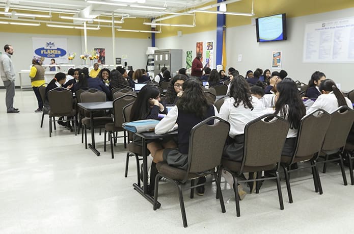 Some of Cristo Rey Atlanta’s 534 students gather in the school cafeteria for one of its two lunch periods. During certain lunch periods, mentors will come and have lunch with their mentees. Photo By Michael Alexander