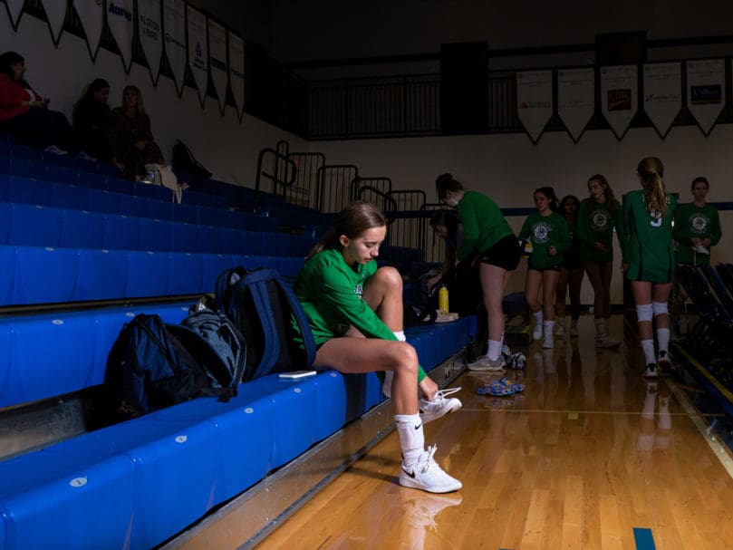 Notre Dame Academy's Ella Bianco (#4) prepares to warm up before the game against Cristo Rey. Photo by Johnathon Kelso