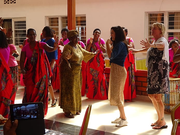 Kathy Montag, CRS capacity building specialist in Atlanta, at right, learns a dance from members of COSOPAX of the Great Lakes Region of Africa. The program helps women in Rwanda and its border countries to build social, cultural and economic relationships to promote peace.