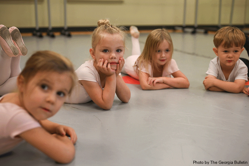 Avery McClure, center, listens intently to her teacher during the beginner ballet class at St. Catherine of Siena Church's Dance Academy. Each class blends technical instruction with encouragement, helping  students develop new skills while showcasing creative expression. Photo by Julianna Leopold